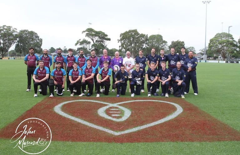 Two youth sports teams lined up on a baseball field standing behind home plate with a heart-shaped logo